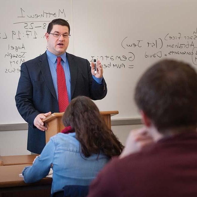 Dr. Leroy Huizenga in front of class giving a lecture